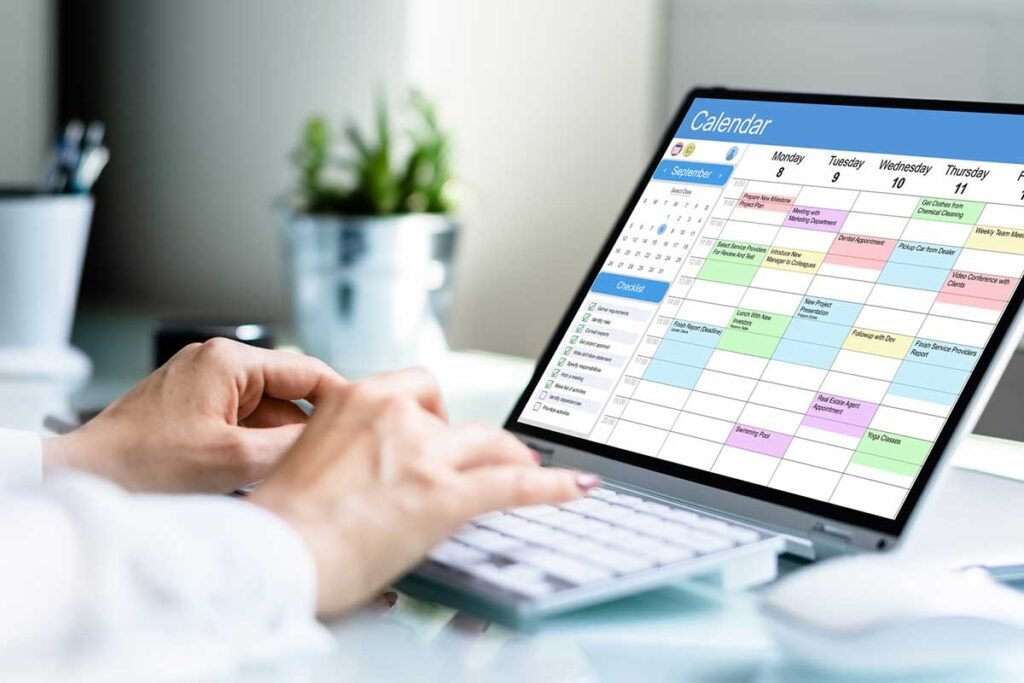 person planning a social media calendar on a laptop with healthcare observance days