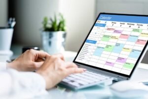 person planning a social media calendar on a laptop with health observance days